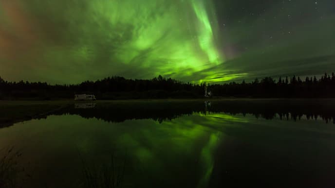 View the Majestic Northern Lights While Floating on a Crystal-Clear Lake