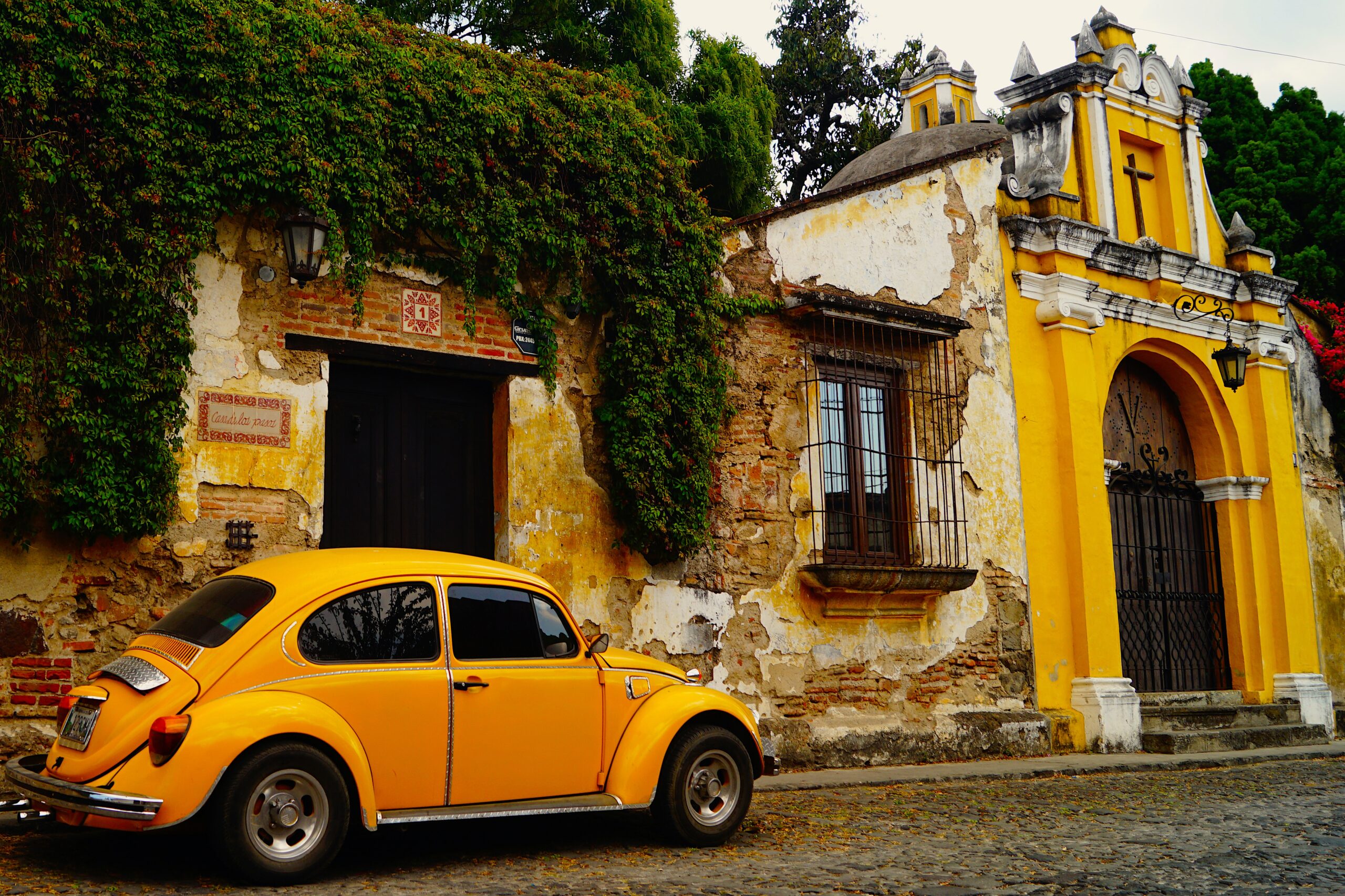 Yellow car in front of colonial architecture in Guatemala